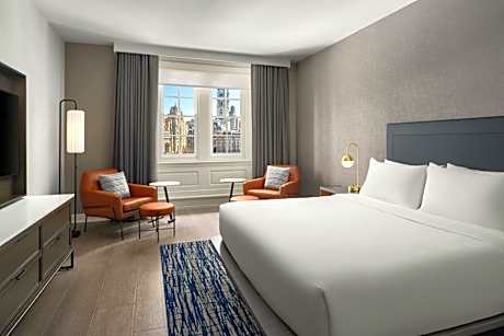 One-Bedroom King Suite with Private Sofa Bed and Atrium View - Mobility and Hearing Accessible with Roll-in Shower