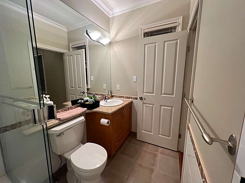 A cozy bedroom with a private washroom close to YVR Richmond