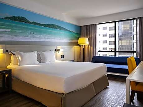 Superior room with 1 king size bed and 1 sofa bed, with partial sea view