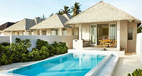 Sun Siyam Olhuveli Maldives: A picturesque view of this luxurious resort, showcasing its overwater villas and pristine white-sand beaches surrounded by crystal-clear turquoise waters, offering a serene tropical retreat.