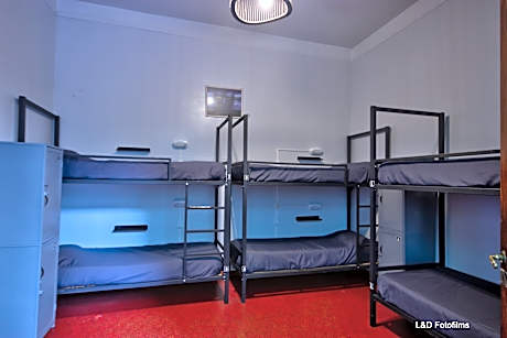 Bed in dormitory with shared bathroom