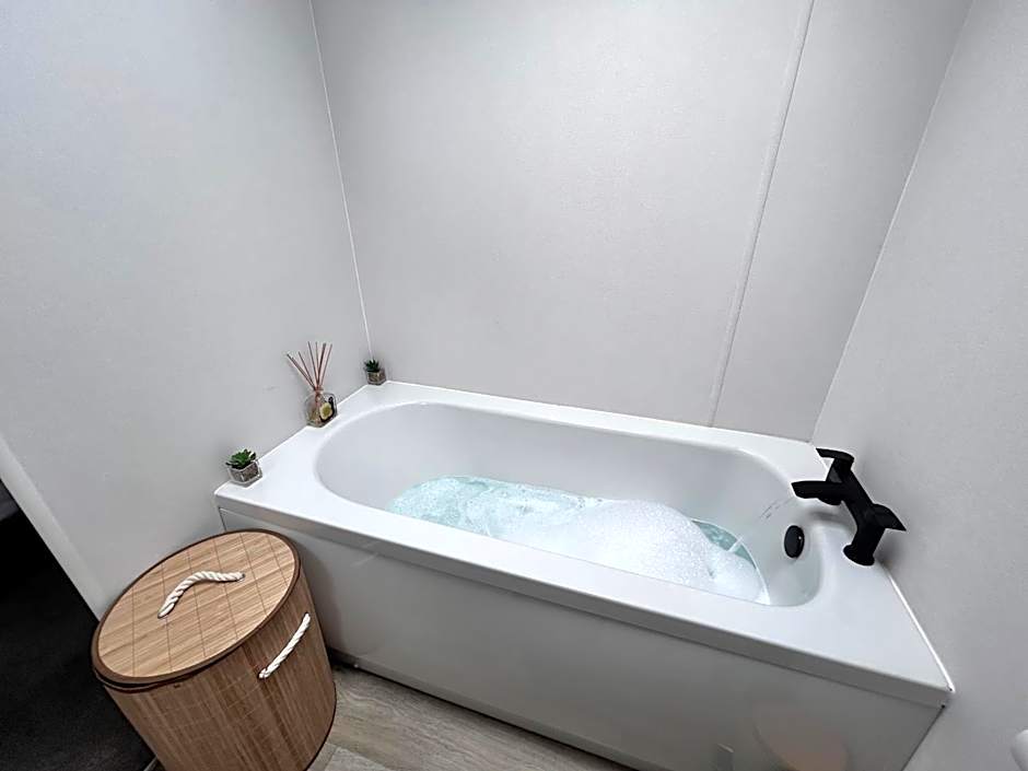 Award winning Serenity Lodge with outstanding lakeside views from the hot tub , at Tallington Lakes Leisure Park, Stamford