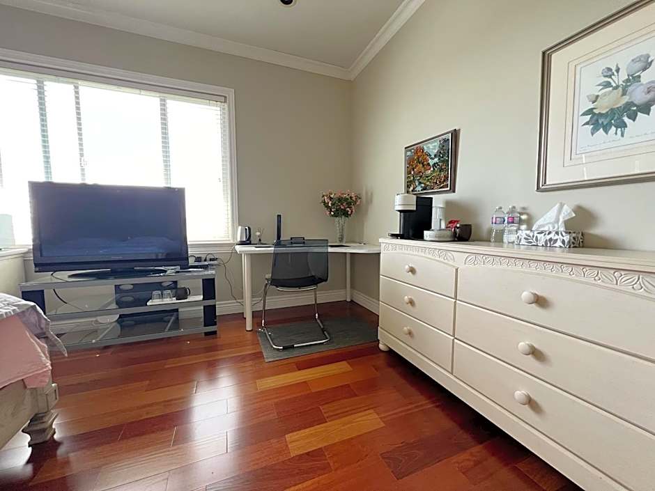 A cozy bedroom with a private washroom close to YVR Richmond