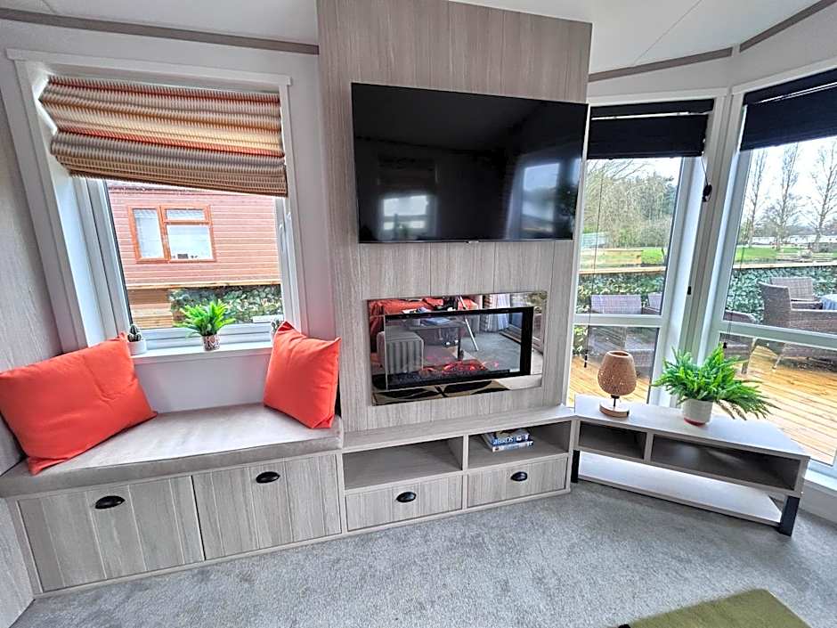 Award winning Serenity Lodge with outstanding lakeside views from the hot tub , at Tallington Lakes Leisure Park, Stamford