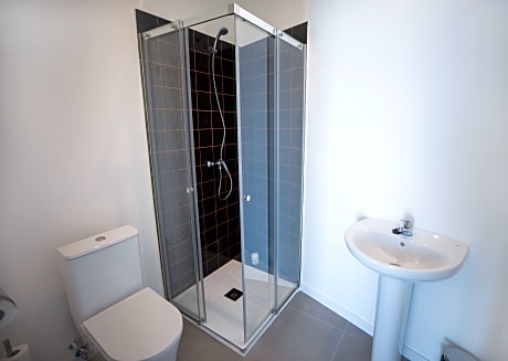 bed in shared room with 10 beds with private bath