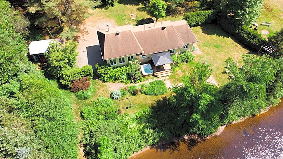 Tranquil Riverfront Chalet with Hot Tub
