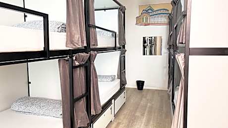 Bed in 8-Bed Dormitory Room with Shared Bathroom