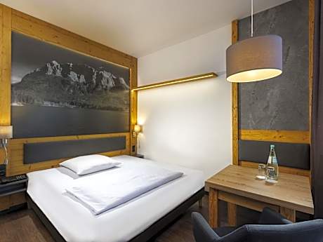 Standard Room with queen-size bed and sofa