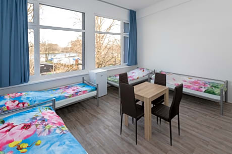 Bed in Quadruple Room with kitchen, shared bath