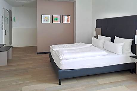 Premium Family Room with Two Queen Beds and Single Sofa Bed
