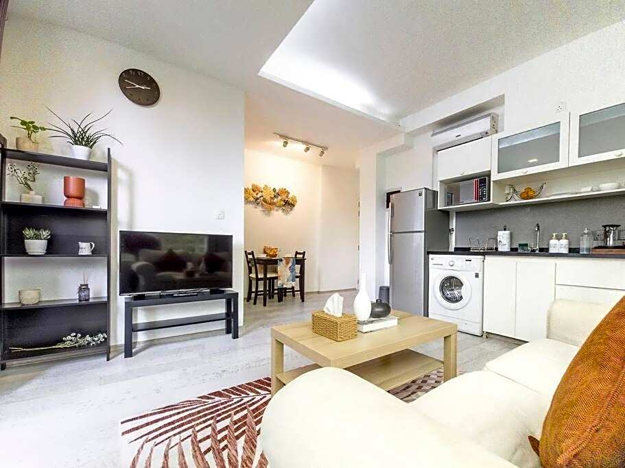 Cozy 1BR apartment by beach - partial ocean view