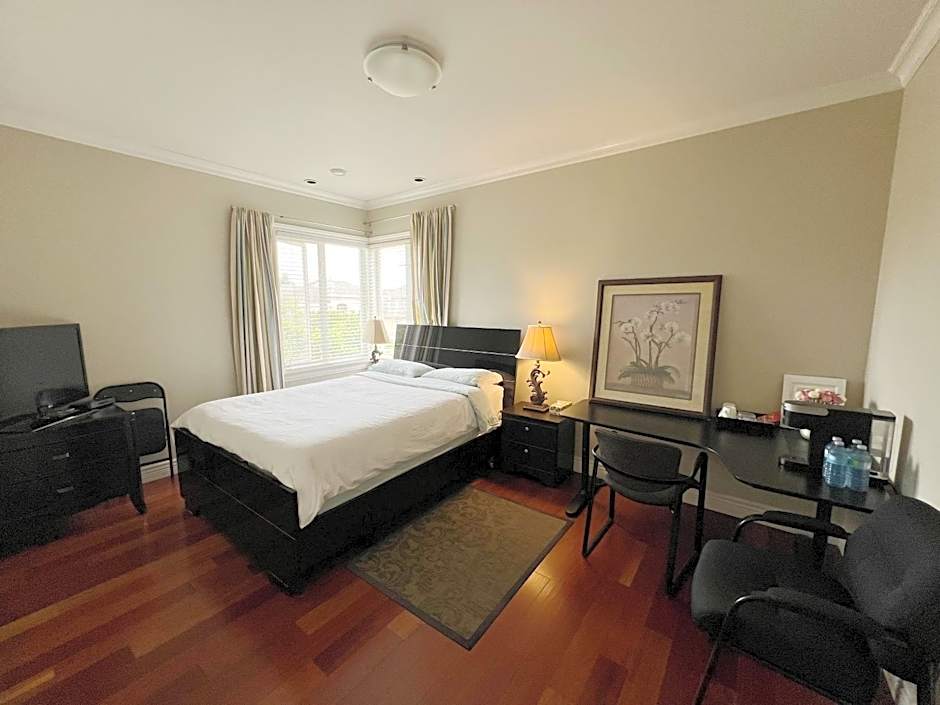 A cozy bedroom with a private washroom close to YVR Richmond