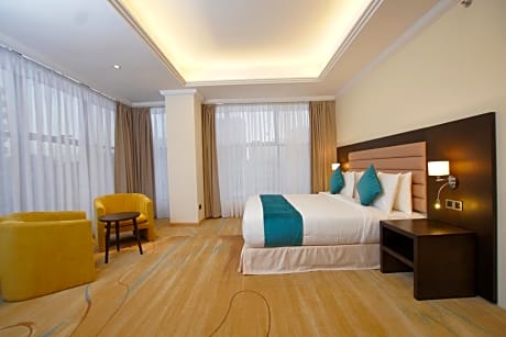 Suite-1 King Bed, Non-Smoking, Premier Room, Separate Living Room, Mini Bar, Wi-Fi, Double Vanity, Full Breakfast