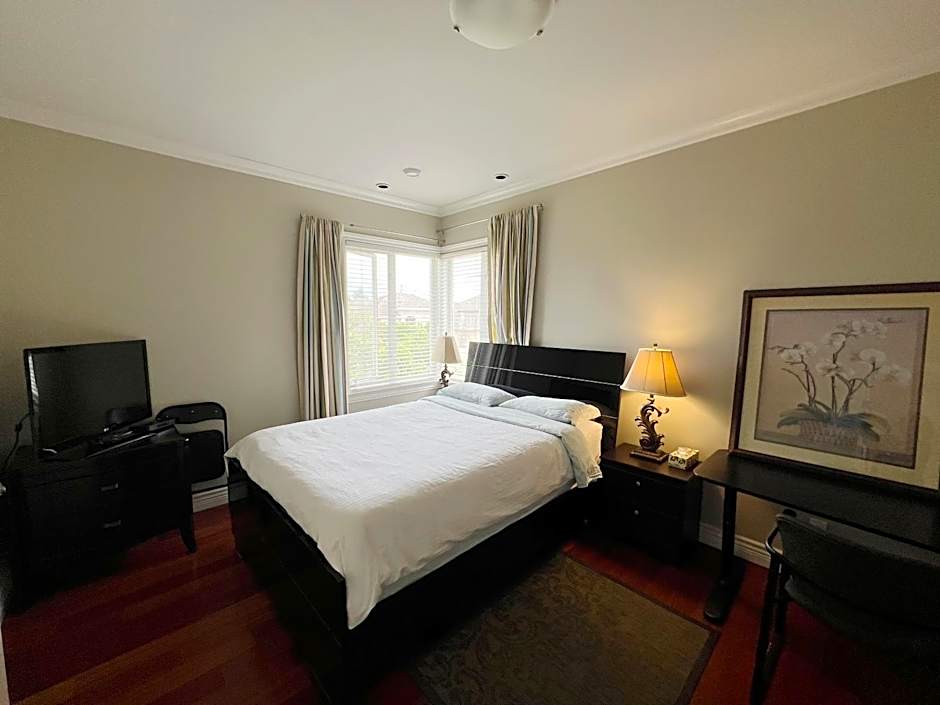 A cozy bedroom with a private washroom close to YVR Richmond