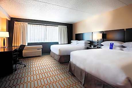 Guest Room with Two Queen Beds and One Sofa Bed - Pool View
