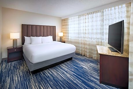 Two-Room Corner King Suite with One King Bed and Sleeper Sofa - Balcony