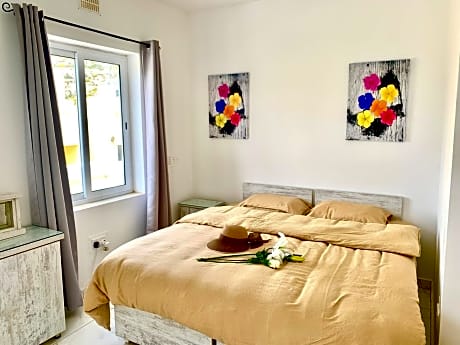 Private bedroom with balcony in a shared apartment at the Bay of Xlendi