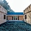 Designed home with bedstead, surrounded by forest