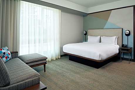 One-Bedroom King Suite with Pool View, Balcony, Conference Space and Sofa Bed