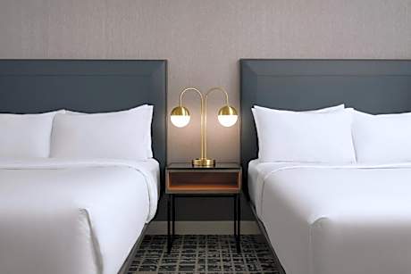 One-Bedroom King Suite with Private Sofa Bed and Atrium View - Mobility and Hearing Accessible with Roll-in Shower