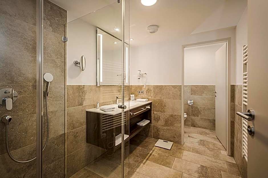 Hotel Norica - Thermenhotels Gastein mit dem Bademantel direkt in die Therme