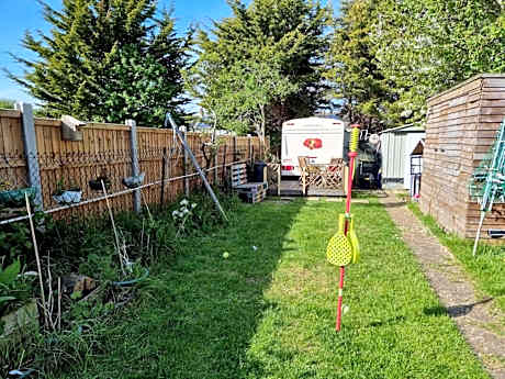 4 berth caravan in a garden, nestled in the trees
