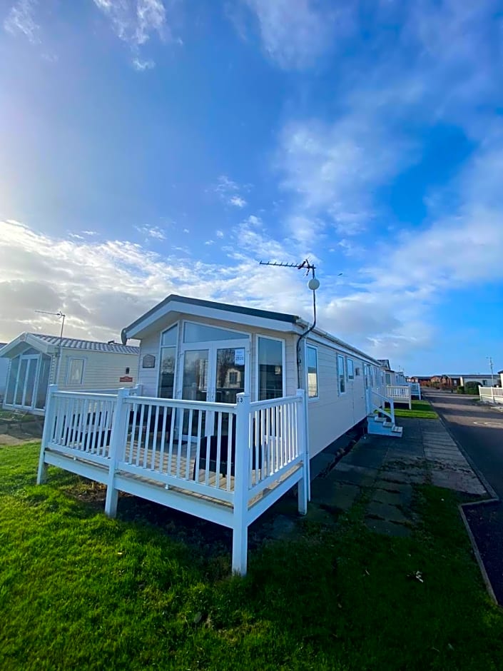 E3 is a 2 Bedroom 6 berth Lodge on Whitehouse Leisure Park in Towyn near Rhyl with Free WiFi, decking and private parking space