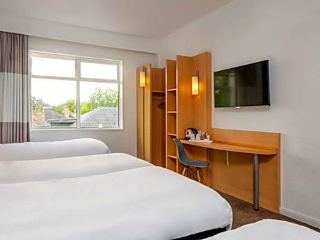 Room with 4 single beds, perfect for a small group or a family