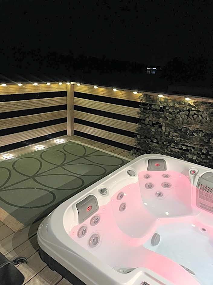 Award winning Serenity Lodge with outstanding lakeside views from the hot tub , at Tallington Lakes Leisure Park, Stamford
