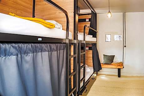 Bed in 100% Female dormitory room with shared bathroom