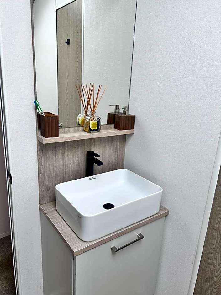 Award winning Serenity Lodge with outstanding lakeside views from the hot tub , at Tallington Lakes Leisure Park, Stamford