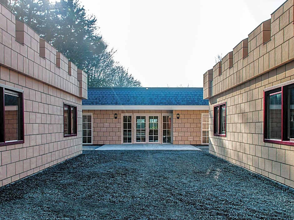 Designed home with bedstead, surrounded by forest