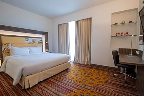 Junior King Suite with Complimentary IMFL from 6:00 pm to 8 pm at Barcode and Two Way Airport Transfer
