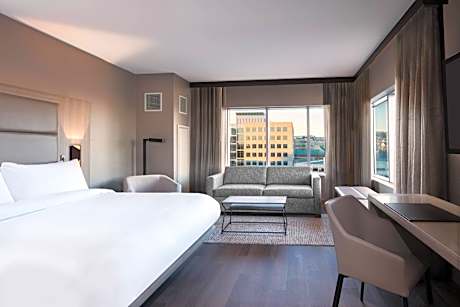 Corner King Guest Room with Sofa Bed and City View