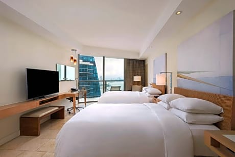 Guest room with 2 double beds, balcony and partial ocean view