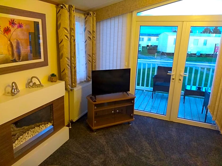 E3 is a 2 Bedroom 6 berth Lodge on Whitehouse Leisure Park in Towyn near Rhyl with Free WiFi, decking and private parking space